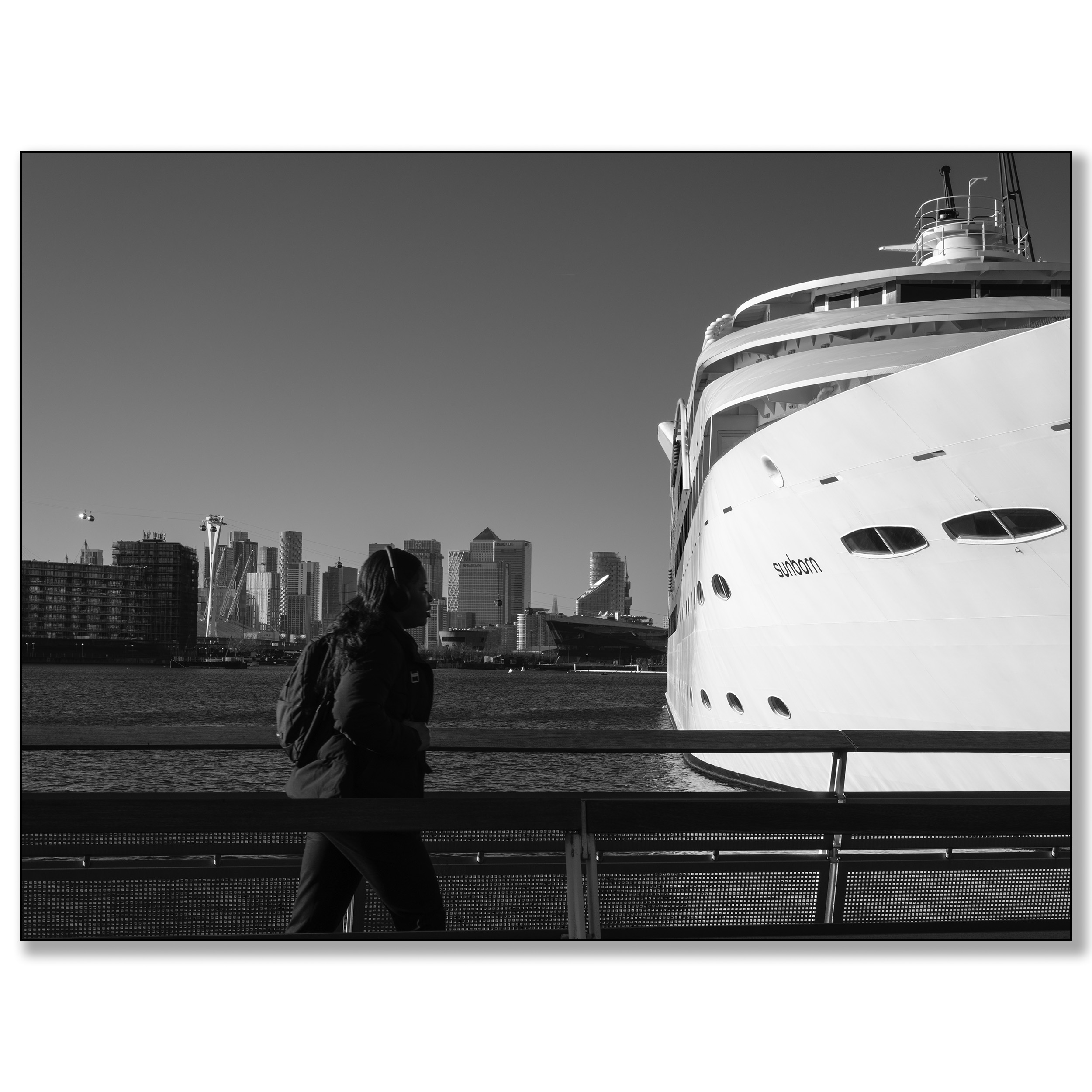 London Royal Victoria Wharf, woman walkin in front of hotel ship