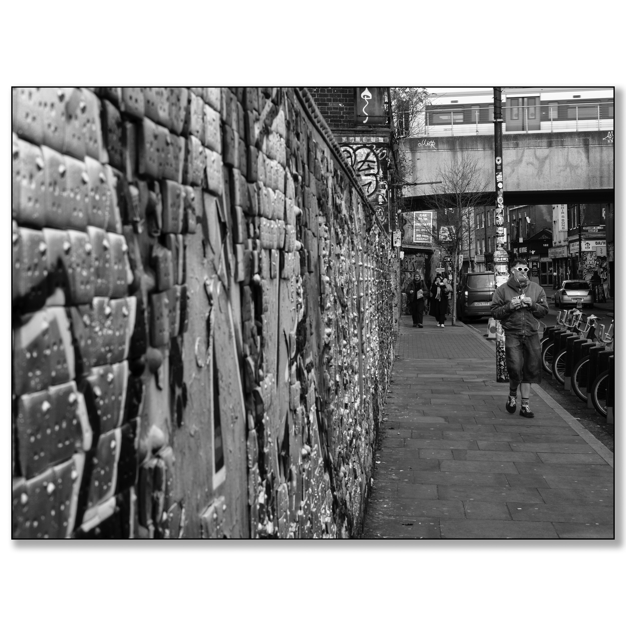 London Brick Lane, gravity wall, man walking